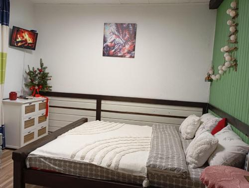 a bedroom with a bed and a dresser at Захарова Оселя БАСЕЙН на території є Чан - Джакузі in Slavske