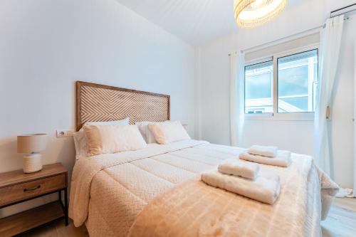 a bedroom with a large bed with two towels on it at Martin´s Place 80 Mts To Beach in Fuengirola