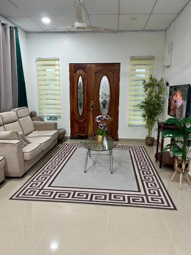 a living room with a couch and a table at TIARA INN Homestay 2 Tingkat Pontian Johor in Pontian Besar