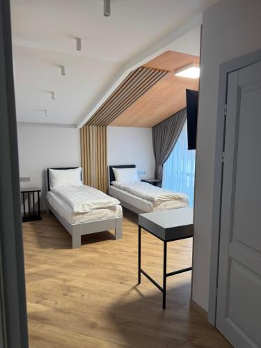 a hotel room with two beds and a table at Апарт Злата in Bukovel