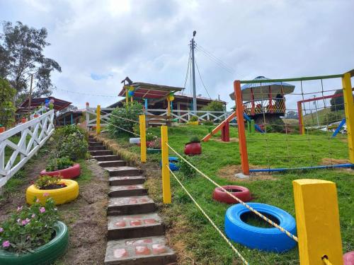 a park with a playground with a slide at La Vaca Fifí in Murillo