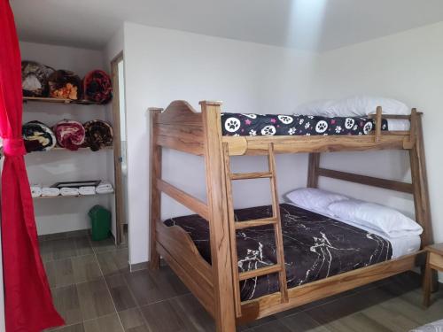 a bedroom with two bunk beds in a room at La Vaca Fifí in Murillo