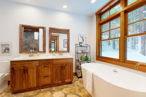a bathroom with a tub and a large window at Snoqualmie Lodge in Snoqualmie Pass