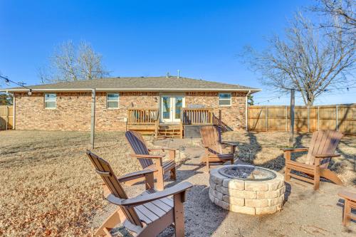 a group of chairs sitting around a fire pit at 4 Mi to Dtwn Guthrie Family Home with Fire Pit! in Guthrie