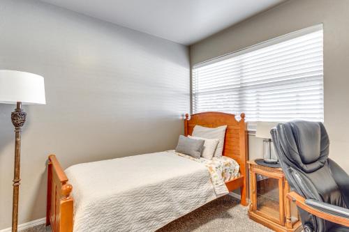 a bedroom with a bed and a chair and a window at 4 Mi to Dtwn Guthrie Family Home with Fire Pit! in Guthrie