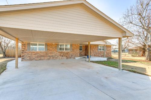a large garage with a roof on a house at 4 Mi to Dtwn Guthrie Family Home with Fire Pit! in Guthrie