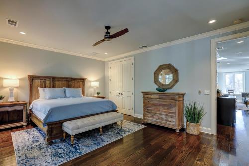 a bedroom with a bed and a mirror on the wall at New Listing 5 BR Luxury Beach Home w Private Pool Three Master Suites Granite in Hilton Head Island