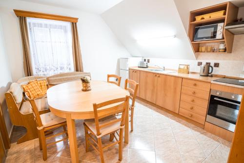 a kitchen with a table and chairs in a room at Chalupa 101 in Vítkovice