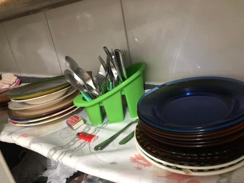 a group of plates and utensils on a counter at Casa na Praia Bertioga in Bertioga