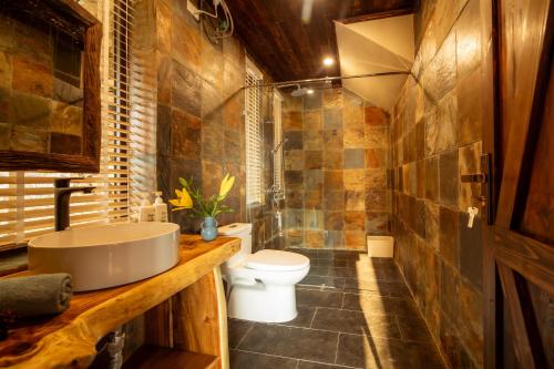 a bathroom with a sink and a toilet in it at Quin home, into the forest, close to Noi Bai airport in Phú Hữu