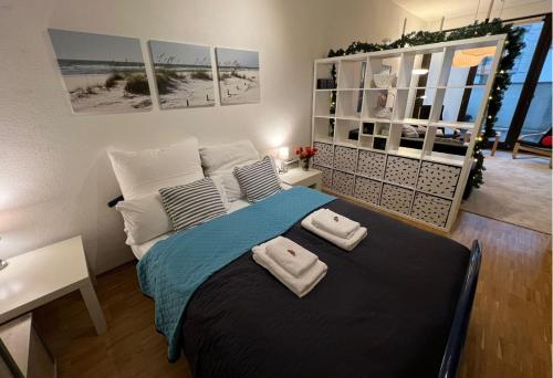 a bedroom with a bed with two towels on it at Terassen Whg 68 qm bis 6 pers in Wiesbaden