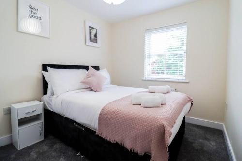 a bedroom with a bed with two towels on it at 3br House With Parking Near Iron Pier Thames River in Woolwich