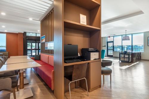 an office with a couch and a desk with a computer at MainStay Suites Fort Myers East I-75 in Fort Myers