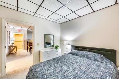 a bedroom with a bed with a blue comforter at 1 Mi to Dtwn Cozy Retreat in New Kensington! in New Kensington
