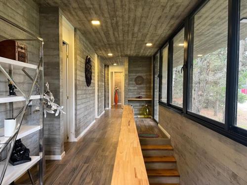 a hallway of a house with wooden floors and windows at Casa de lujo en Costa Esmeralda in Costa Esmeralda