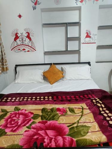 a bedroom with a bed with flowers on it at Bagol Palace in Udaipur