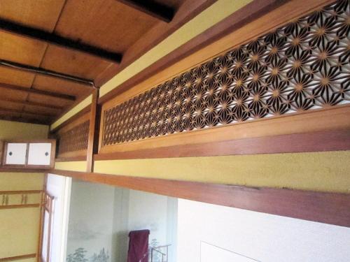a wooden wall with a american flag on it at Ryokan Taishoro in Sakurai
