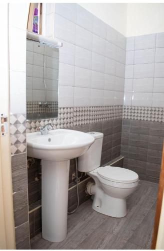 a bathroom with a toilet and a sink at Urban retreats ELD in Eldoret