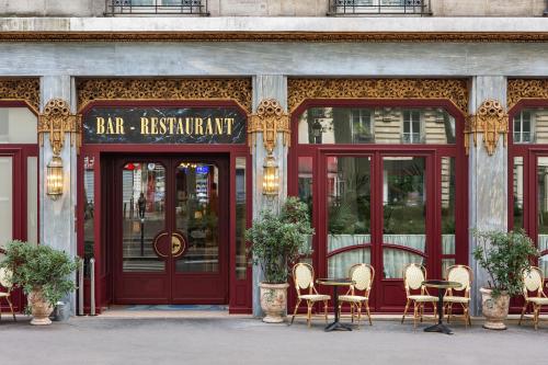 a restaurant with red doors and chairs in front at Hotel Rochechouart - Orso Hotels in Paris