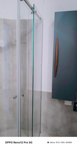 a shower with a glass door in a room at Affittacamere Roberta in Osimo