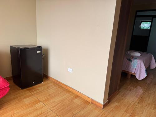 a room with a small refrigerator in the corner of a room at Hotel Precursores in Lima
