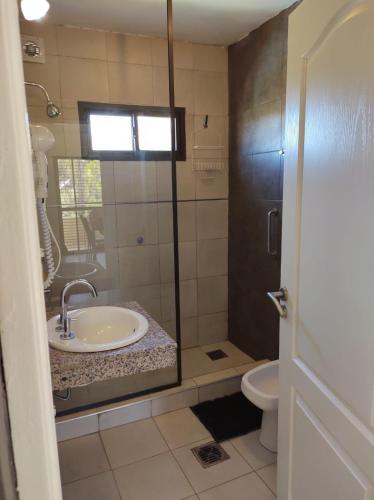 a bathroom with a sink and a toilet at Pauvalén Departamentos in Potrero de los Funes