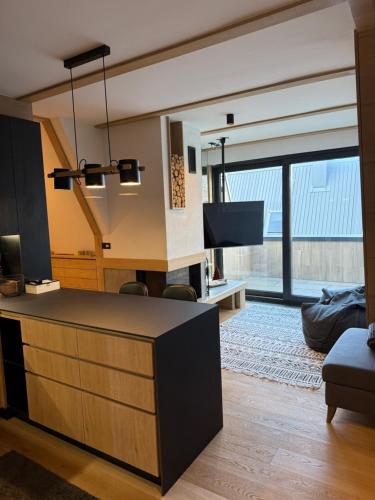 a living room with a reception desk with a large window at Ski & Relax Apartment Bjelašnica in Bjelašnica