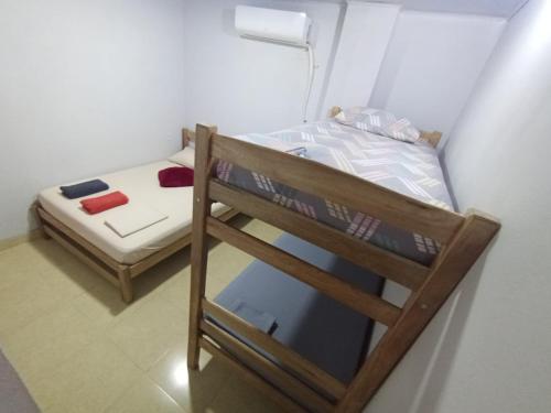 a small room with a bunk bed and a small bed at Casa Macondo RDM in San Onofre
