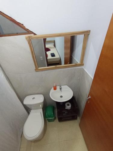 a small bathroom with a toilet and a sink at Casa Macondo RDM in San Onofre