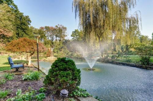a fountain in the middle of a pond in a park at The African Queen in Springfield