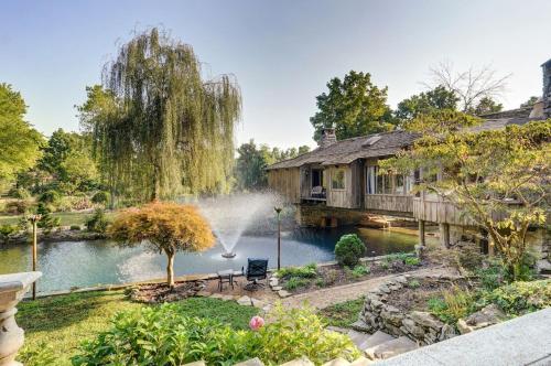 a home with a pond and a house with a fountain at The African Queen in Springfield