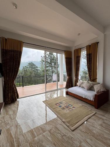 a bedroom with a bed and a large window at Tea Hills Lake in Hatton