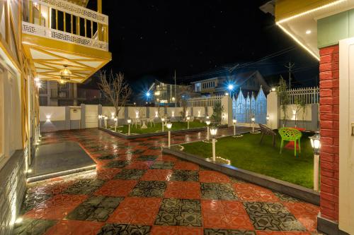 a patio at night with lights on a yard at PalPenzy - Bespoke Premium Stay in Srinagar