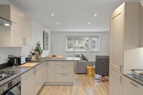 a kitchen with white cabinets and a counter top at Ranalegh Court in Saint Columb Minor