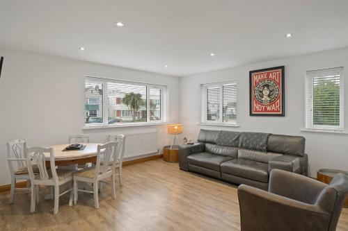 a living room with a couch and a table at Ranalegh Court in Saint Columb Minor