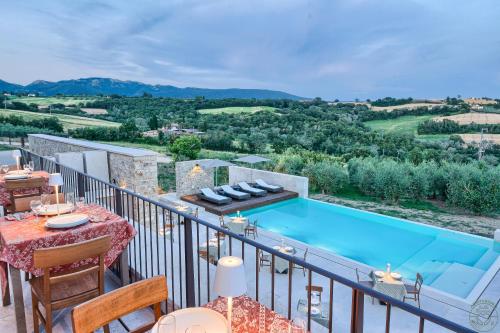a villa with a swimming pool on a balcony at Agriturismo Colli Martani in Massa Martana