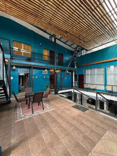 a room with a table and benches in a building at Hotel Las Colinas in Fortuna