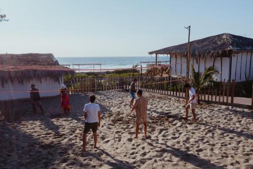 a group of people playing a game on the beach at El Refugio de Vichayito in Vichayito