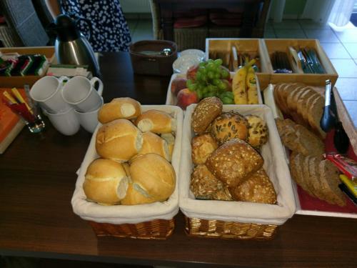 two baskets of bread and other foods on a table at Pension Villa Strandläufer in Norddeich