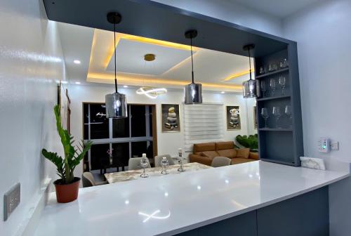a bathroom with a sink and a living room at Apartamento in Mendoza