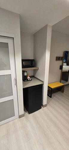 a room with a kitchen with a counter and a microwave at Comfort Suites Conway in Conway