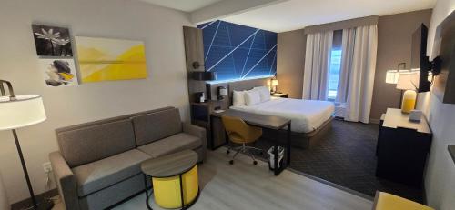 a hotel room with a bed and a couch at Comfort Suites Conway in Conway