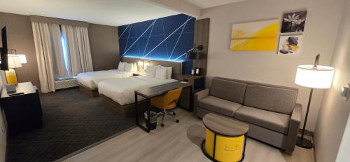 a hotel room with a bed and a couch at Comfort Suites Conway in Conway
