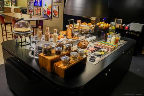 a buffet of food on a black table at Campanile Montargis - Amilly in Amilly