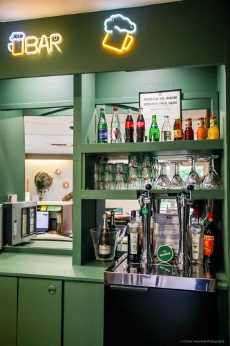 a bar with a lot of bottles of soda at Campanile Montargis - Amilly in Amilly