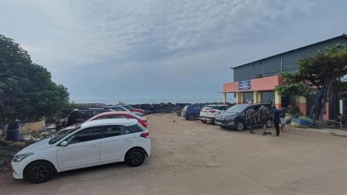 a car parked in a parking lot next to a horse at DIVINE BEACH INN - The sea shore hotel in Puducherry