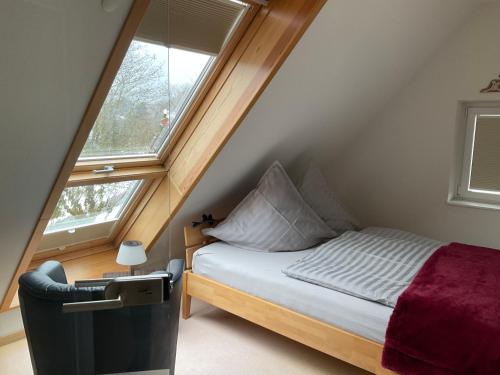 a small bedroom with a bed and a window at Ferienwohnung Holzer am Titisee in Titisee-Neustadt