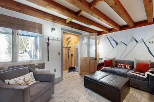 a living room with a couch and a table at Riverbend Ski Retreat in Bethel