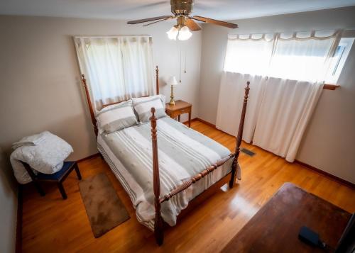 a bedroom with a bed and a ceiling fan at Amazing House Hot Tub Mins To Major Hospitals in Middle Valley