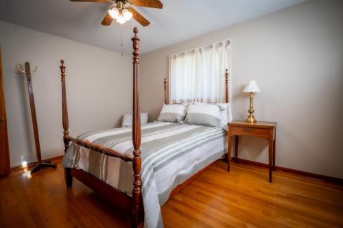 a bedroom with a bed and a ceiling fan at Amazing House Hot Tub Mins To Major Hospitals in Middle Valley